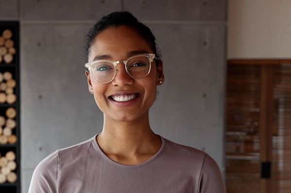 confident young woman smiling directly at the camera